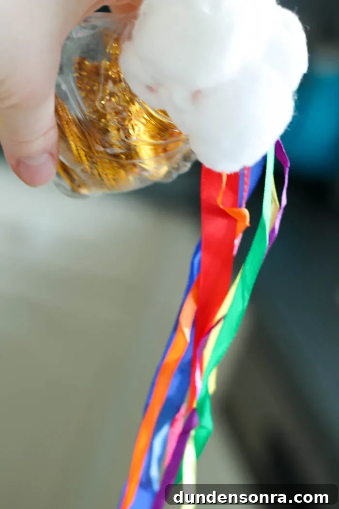 Rainbow Shaker Craft Hand holding a pot of gold rainbow shaker.
