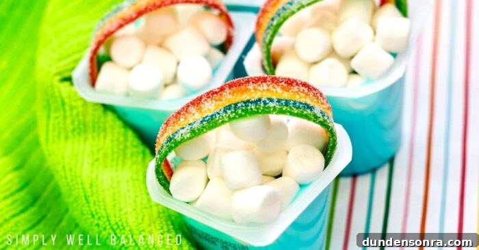 Rainbow Pudding Cups Pudding cups with marshmallows and rainbow gummy on top.