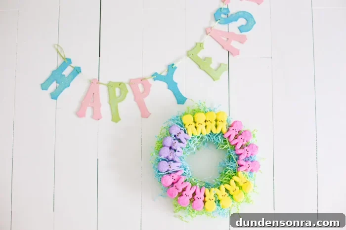 Small peep marshmallow wreath next to a sign that says Happy Easter. 