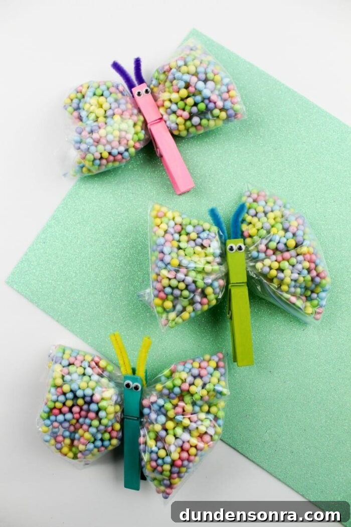 Bags of candies clipped together with a clothes pin to look like a butterfly. 