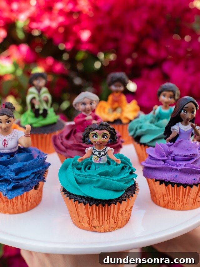 Cupcakes with different Encanto characters on top. 