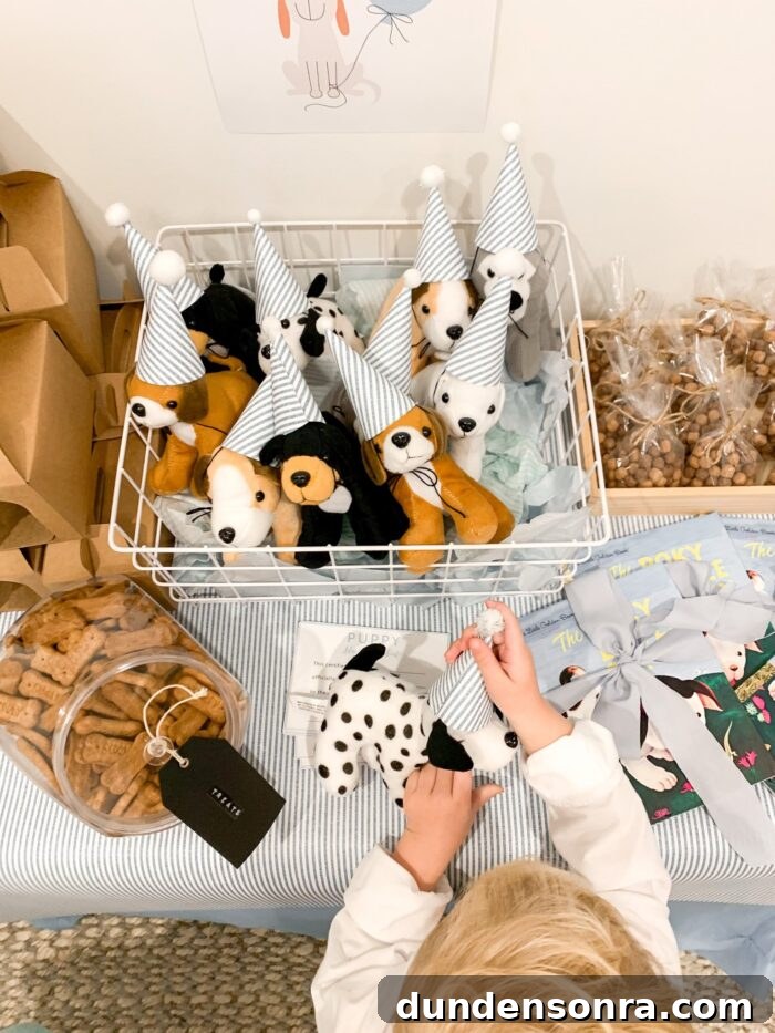 Child's hands placing a hat on a stuffed dog, with more stuffed dogs in a basket. 