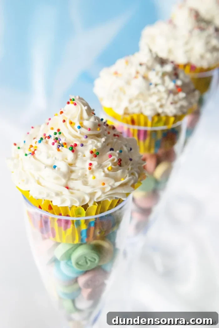 Birthday Gala Party Champagne glasses with candies in the bottom and cupcakes on top.