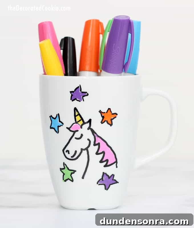 Craft Party Mug with pens in it and a unicorn design on it.