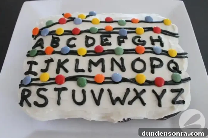 Stranger Things Party Cake with alphabet and colored candies on it.
