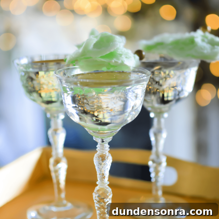 Mocktail Party Three tall glasses with liquid in them and cotton candy on top.