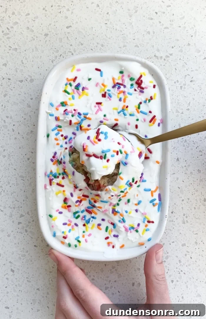Birthday Brunch Small baking dish with baked oats and sprinkles on top with a spoon taking a bite.