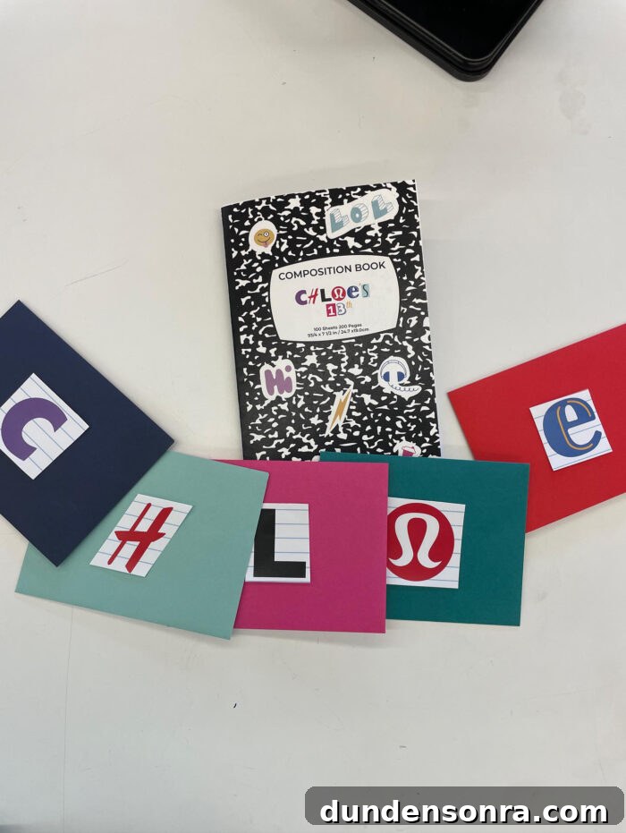 Scavenger Hunt Party Notebook next to pieces of paper with logos on them.