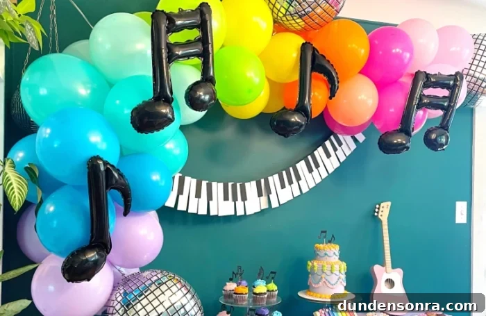One Hit Wonder Birthday Party Party table with bright balloons and music note balloons.
