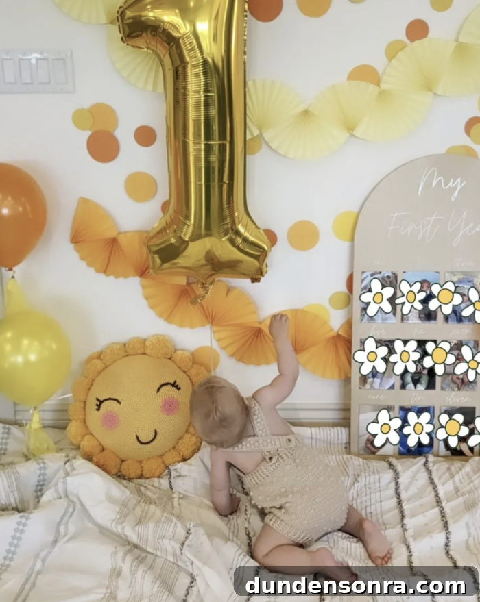 You are my Sunshine Birthday Large "1" balloon with yellow decorations and a baby looking up at it.