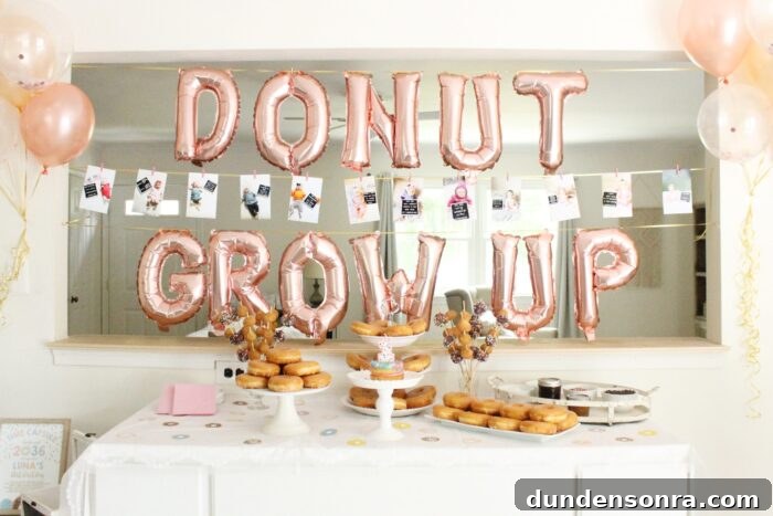 Donut Grow Up Party Table with donuts and balloons that say "donut grow up".