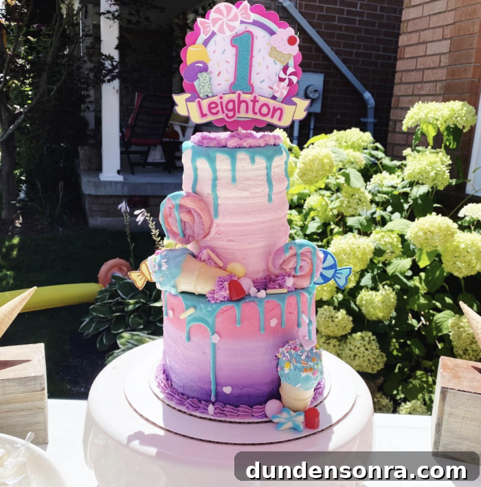 Sweet One Birthday Party Large colorful cake with candy decorations.
