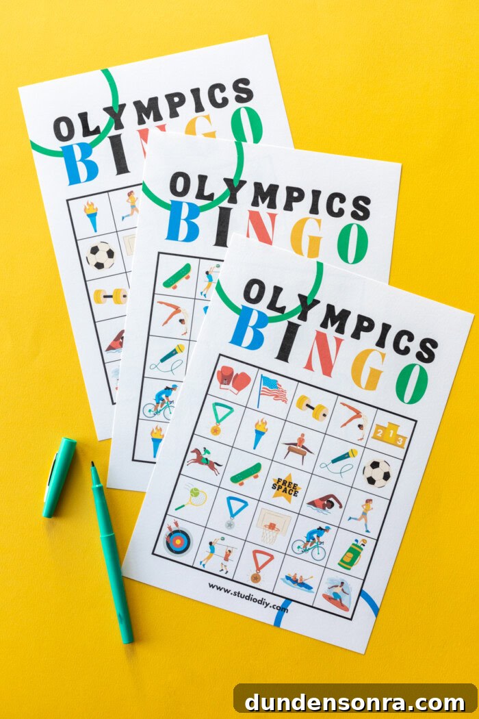 Three Olympics bingo cards on a yellow background next to green markers. 