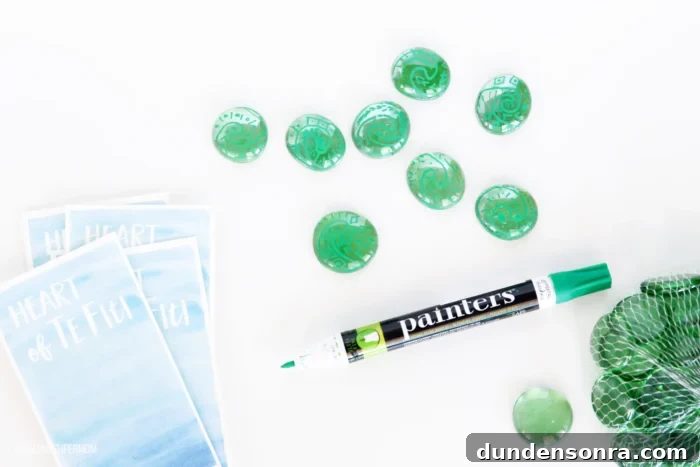 Moana Craft Hearts of Te Fiti craft designed with green pebbles and green markers.