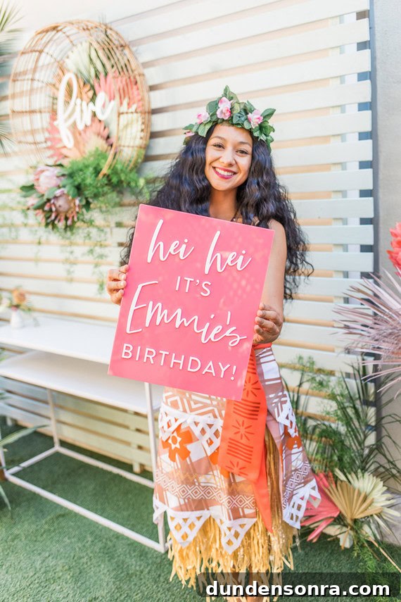 Moana Meet and Greet Person dressed up as Moana holding a sign that says