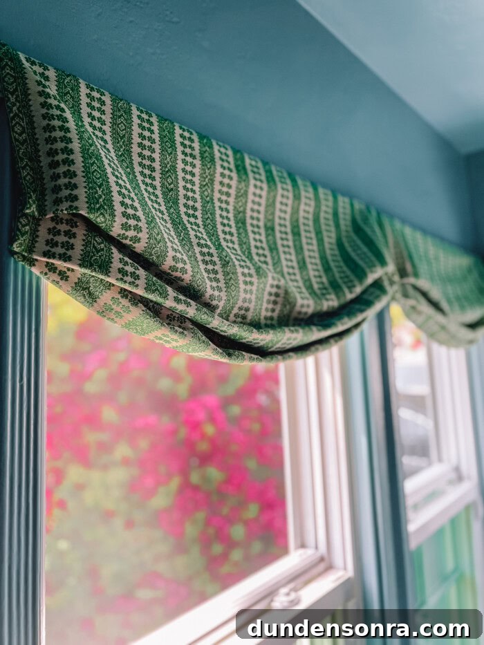 faux roman shade hanging above window