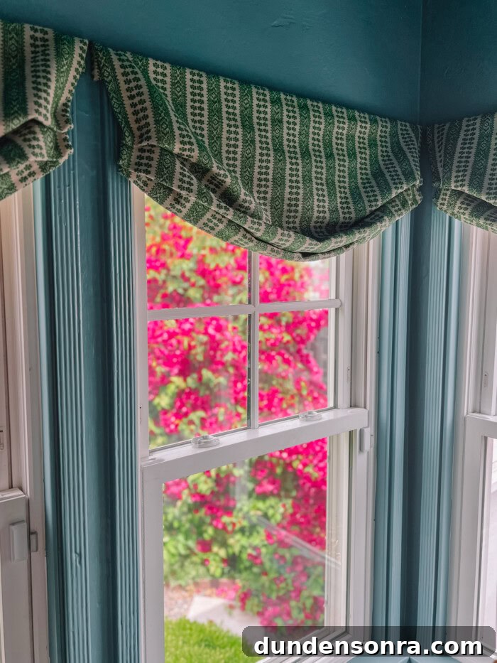 faux roman shades on windows with bougainvillea outside