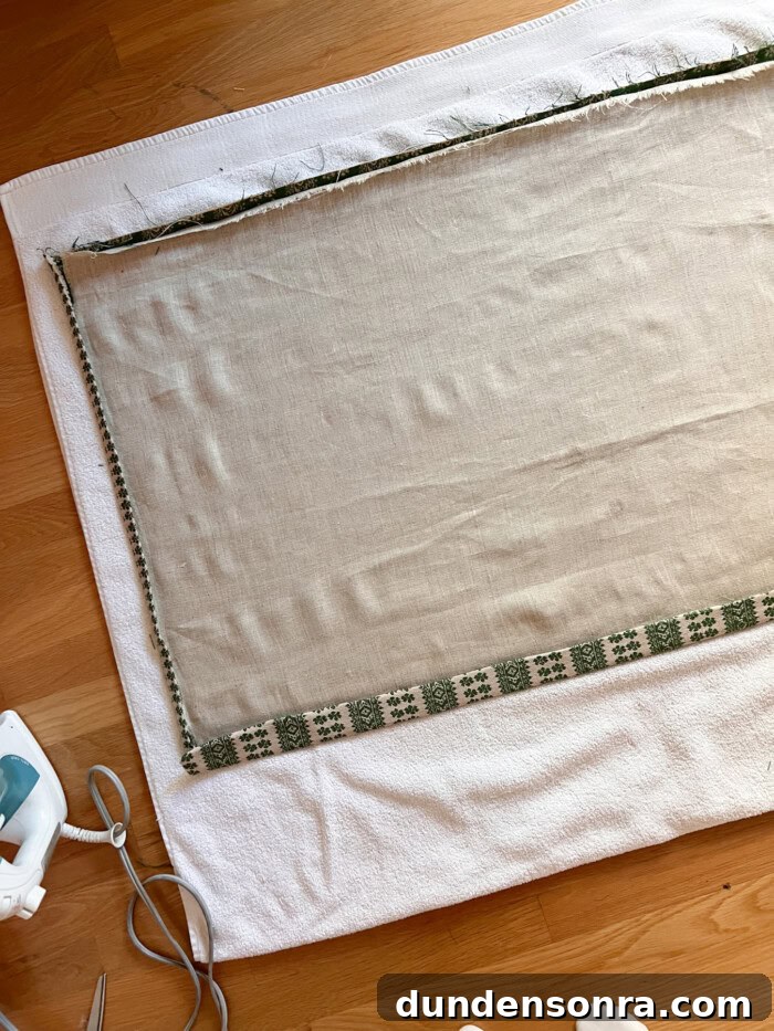 fabric laying on towel on wood floor