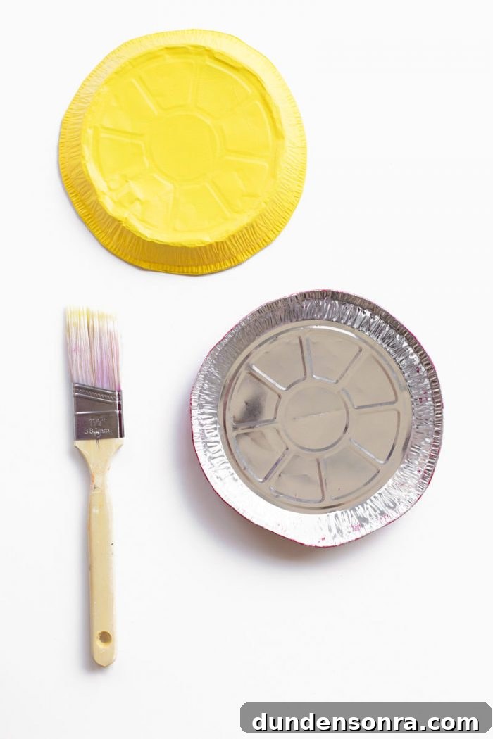 A tin tray and paint brush.