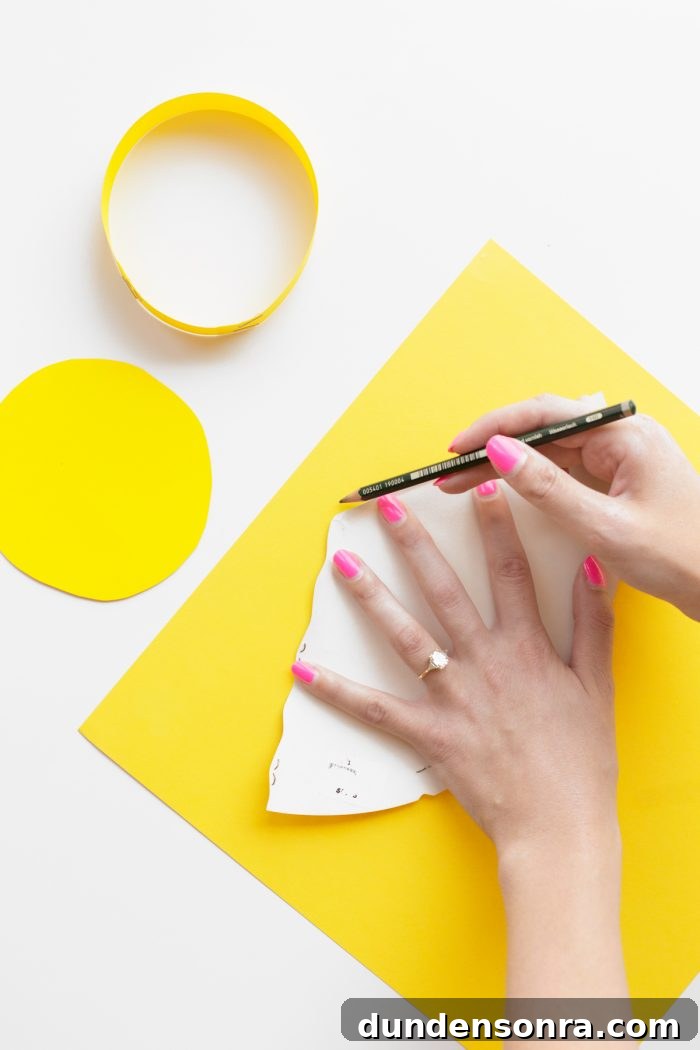 Someone cutting something on yellow paper
