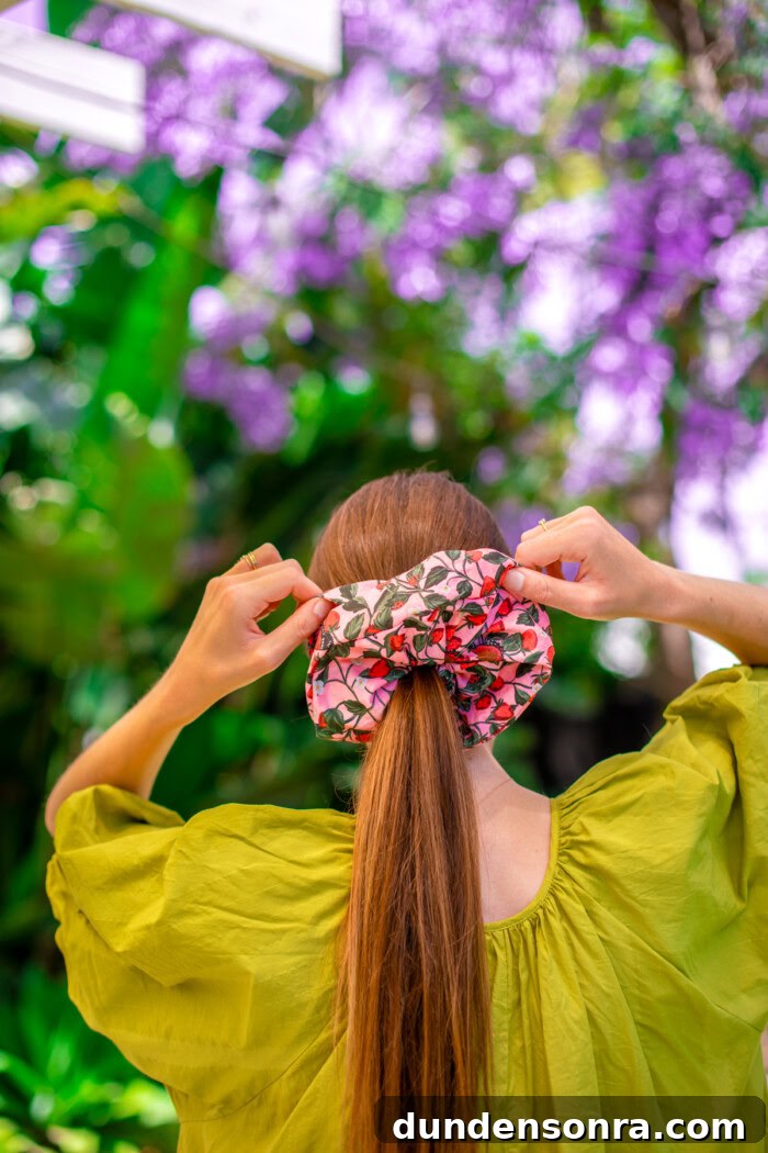 woman adjusting oversized scrunchie