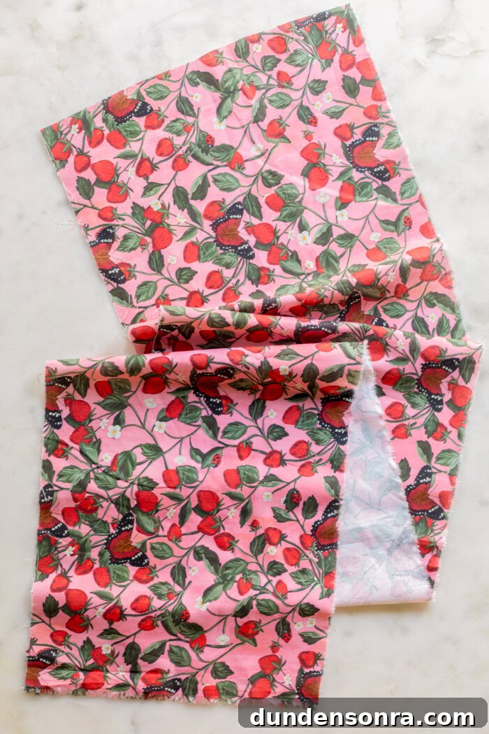 long piece of pink floral and strawberry fabric