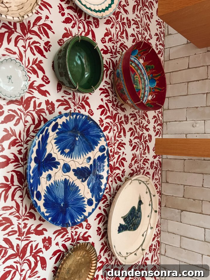 Plate wall on wallpaper with tile and shelves