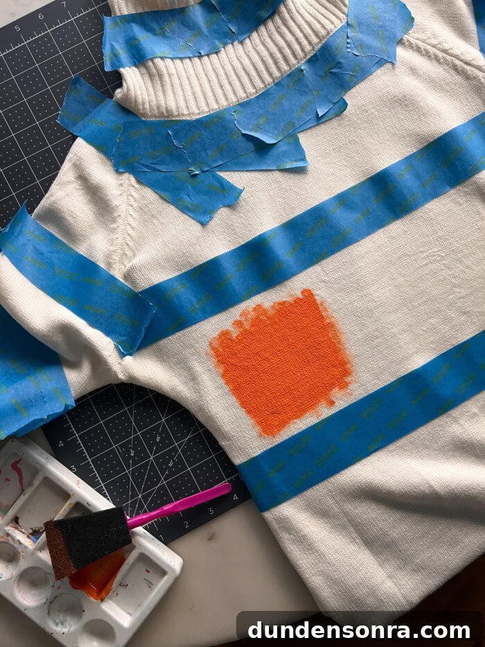 Painting orange stripes on sweater