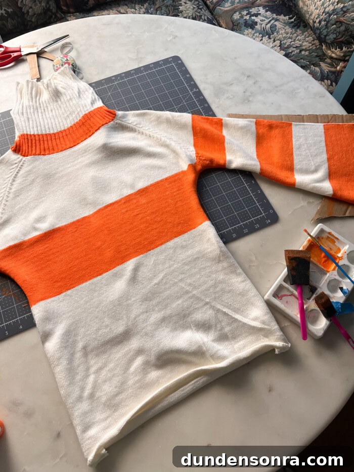 Orange stripe sweater being painted