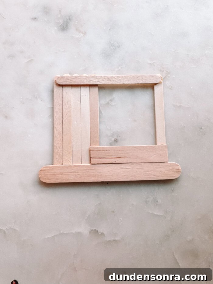 DIY Popsicle Stick Storefront Ornaments: Charming Mini Shop Decor 6 popsicle sticks forming a store on marble
