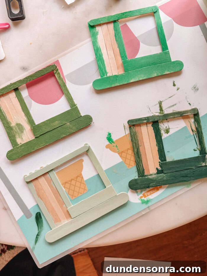 DIY Popsicle Stick Storefront Ornaments: Charming Mini Shop Decor 7 painted popsicle sticks in progress