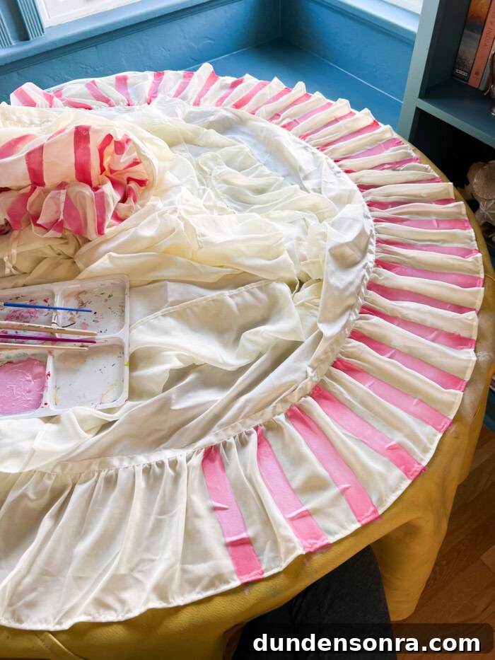 Mary Poppins Returns DIY Costume Ideas for Adults and Kids 5 painting pink stripes on white skirt on table